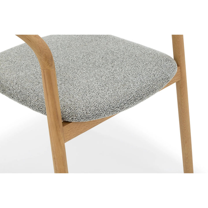 Macro close-up of Celeste Oak Dining Chair Noel fabric seat showing light grey woven texture and solid oak frame detail