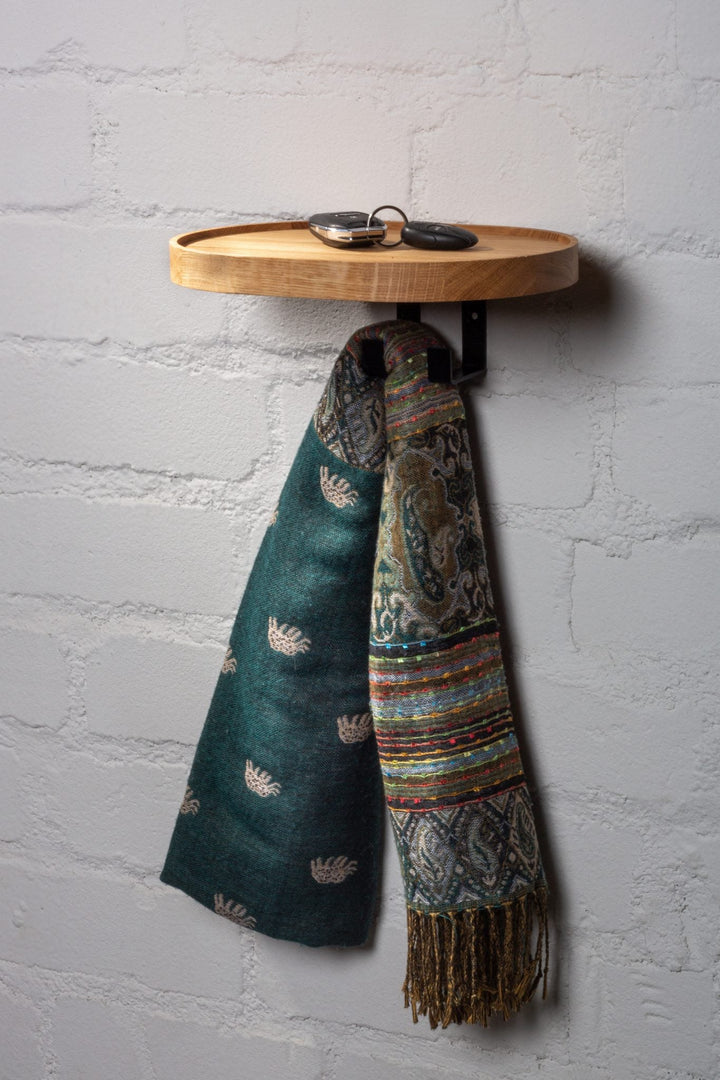 Natural oak wall coat rack with metal hooks and small storage tray for entryways