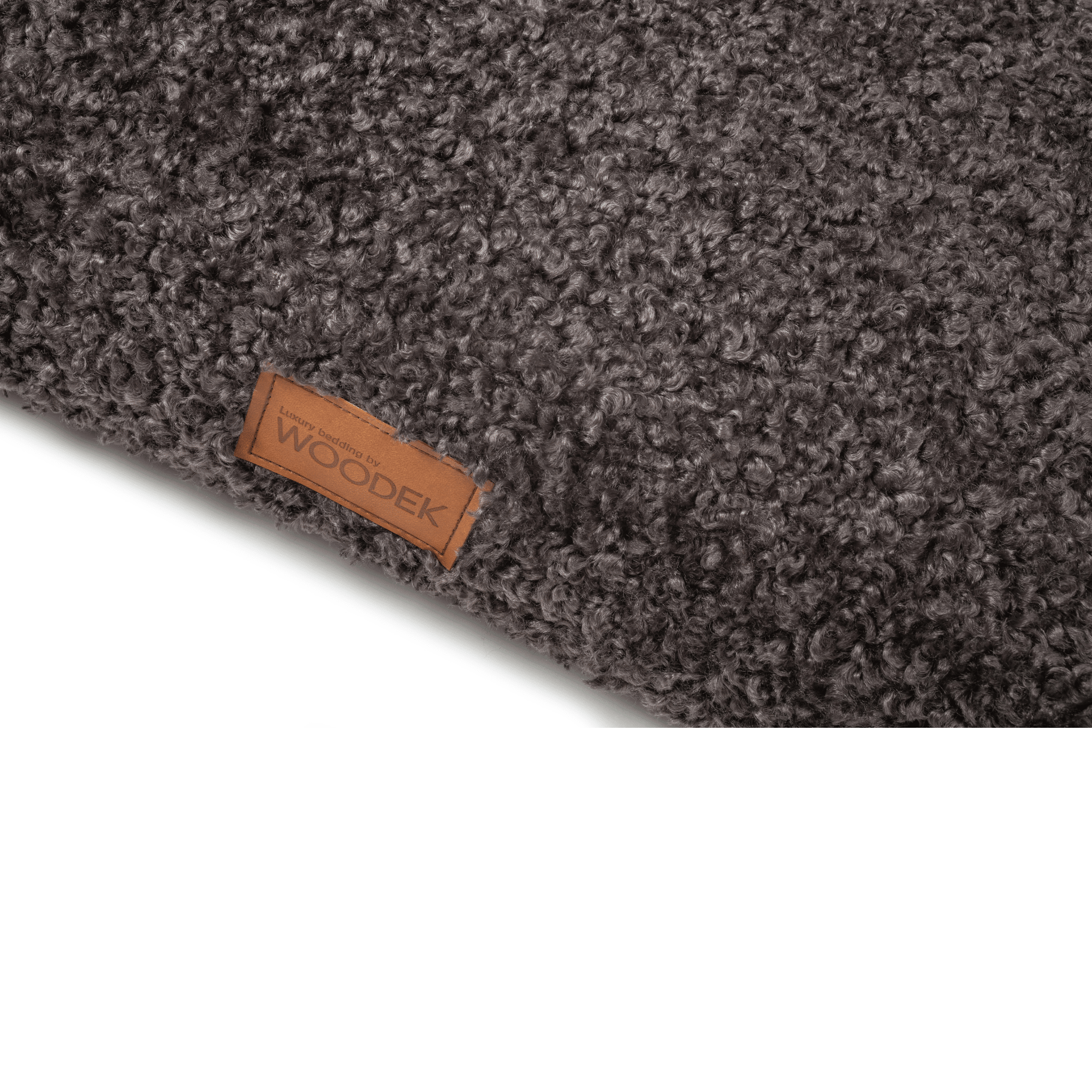 Close-up of the soft textured surface and luxury branding on a gray pet mattress by Woodek.