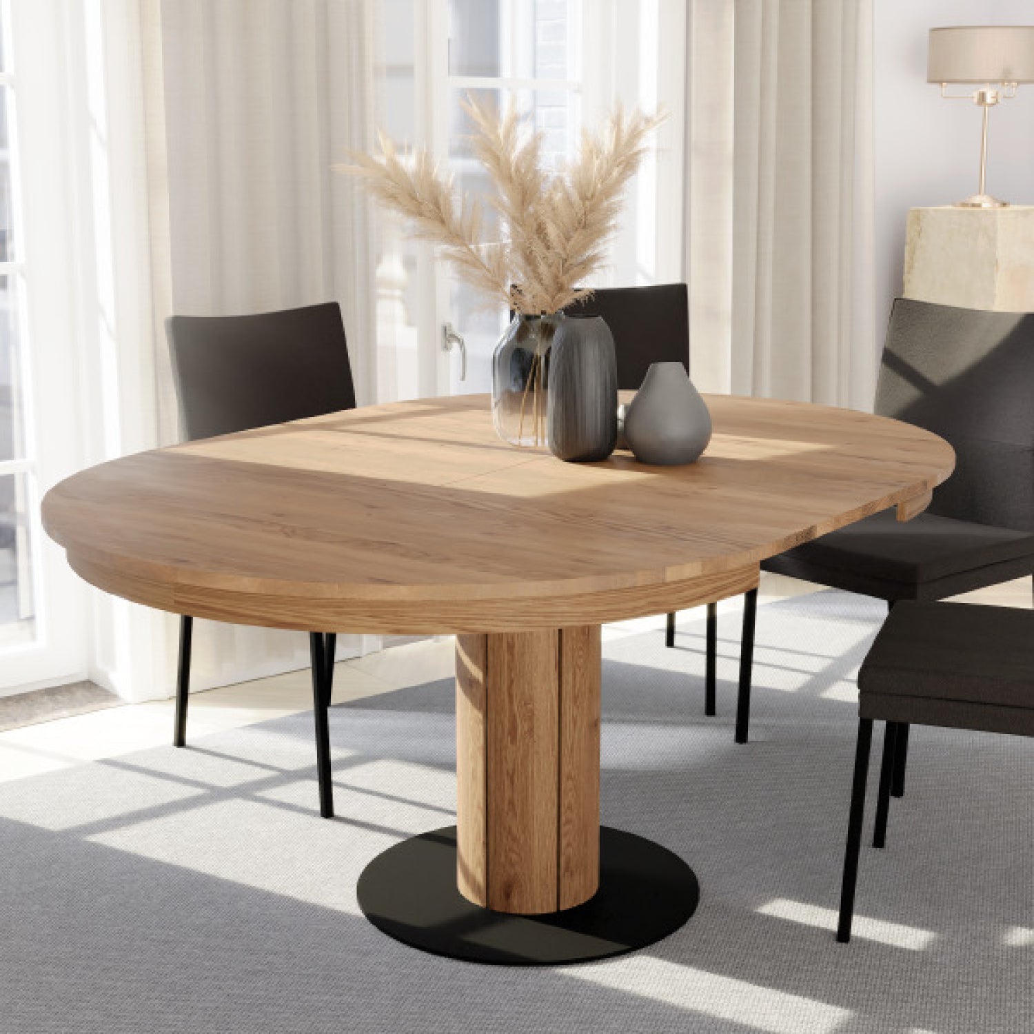 Artisanal solid oak extendable table with circular top and rustic natural finish