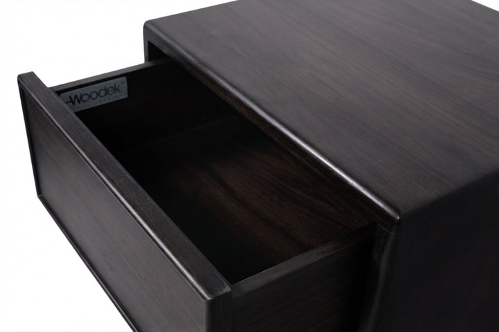 Close-up of a dark wood drawer with one drawer pulled open, showing a wood grain finish and a small Woodek label inside the drawer.