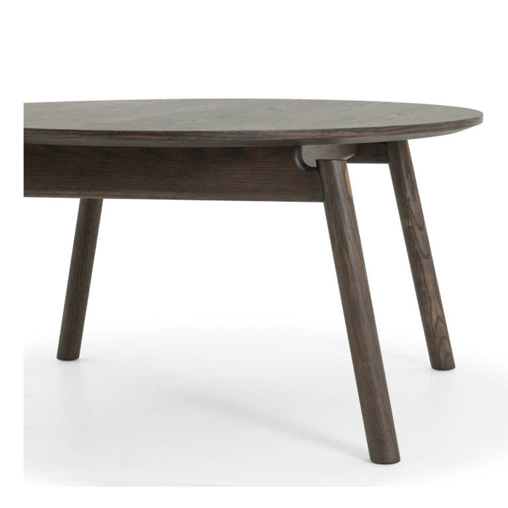 Espresso finished Oak Coffee Table Celeste close-up of angled legs and round top edge in solid oak wood, minimalist Scandinavian design, gallery 1 file Diivanilaud-Celeste-Espresso-5.webp