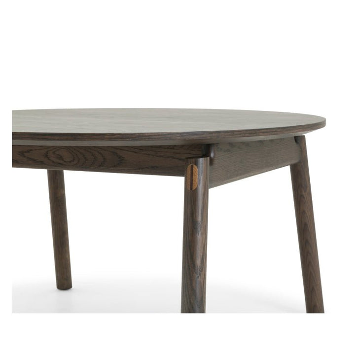 Espresso finished Oak Coffee Table Celeste close-up of round top and angled legs with contrasting wood joinery in minimalist solid oak design