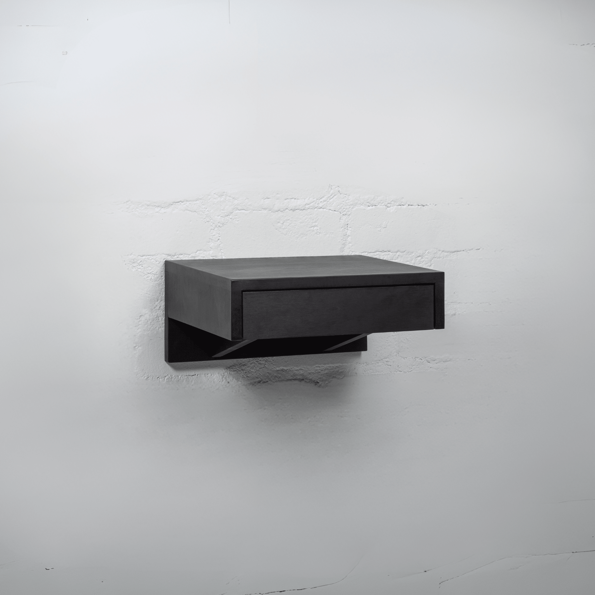 A black wooden nightstand with an open drawer revealing spacious storage for organizing bedroom essentials