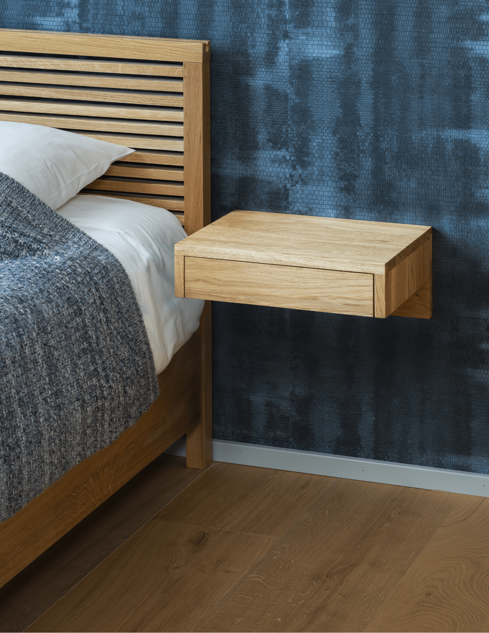 Compact floating oak nightstand with smooth drawer and minimalist modern design