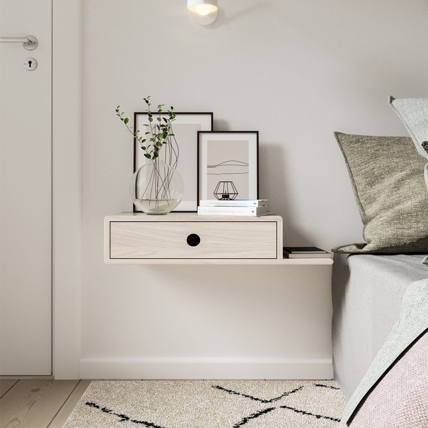Floating nightstand mounted on a white wall, featuring a single drawer with a minimalist black finish