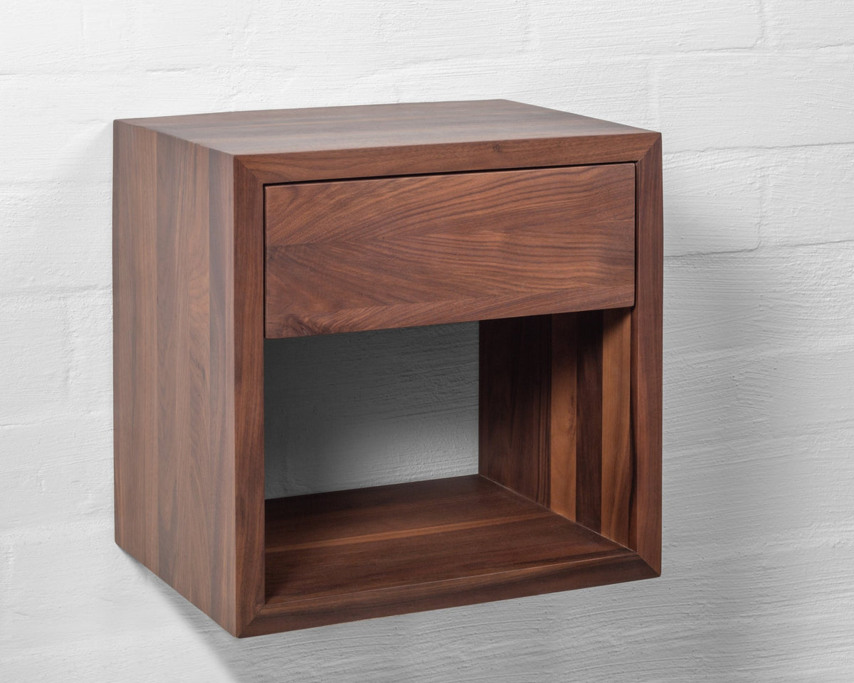 Hugo Floating Nightstand angled view on white background showing rich walnut grain, push-to-open drawer, and open lower shelf
