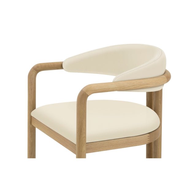 Close-up of Nature Oak Dining Chair upper frame showing curved oak armrest, rounded beige leather backrest, and seat cushion