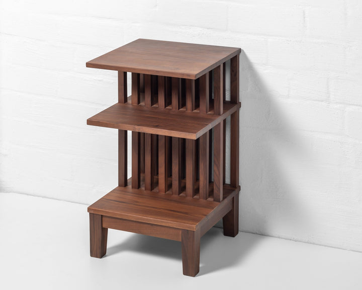 Modern walnut nightstand with three open surfaces and natural wood grain texture