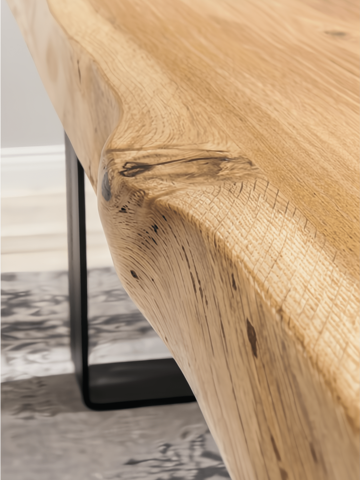 Oaken Dining Table – Handcrafted Solid Oak Hardwood with natural live edge and black metal leg, close-up in minimalist setting, oaken.png gallery 1
