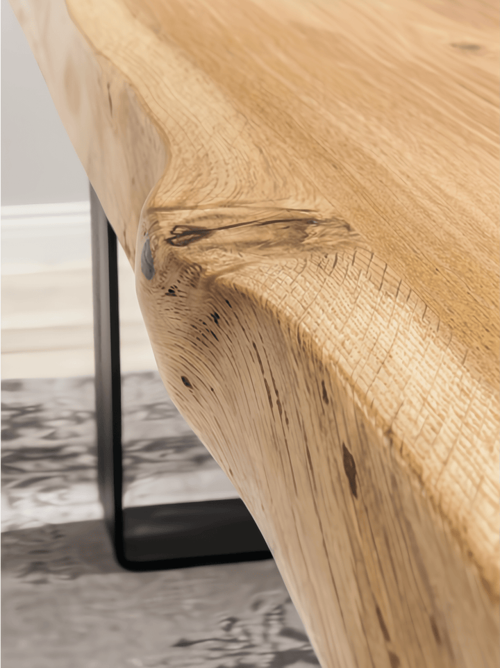 Oaken Dining Table – Handcrafted Solid Oak Hardwood with natural live edge and black metal leg, close-up in minimalist setting, oaken.png gallery 1