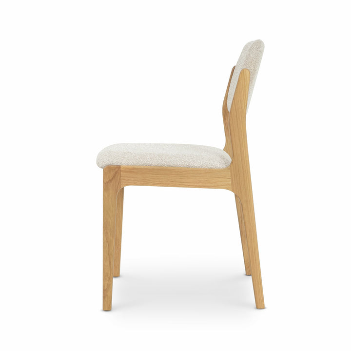 Oslo Dining Chair - Cobble 110 Fabric with natural solid oak frame and light textured beige upholstery, side view