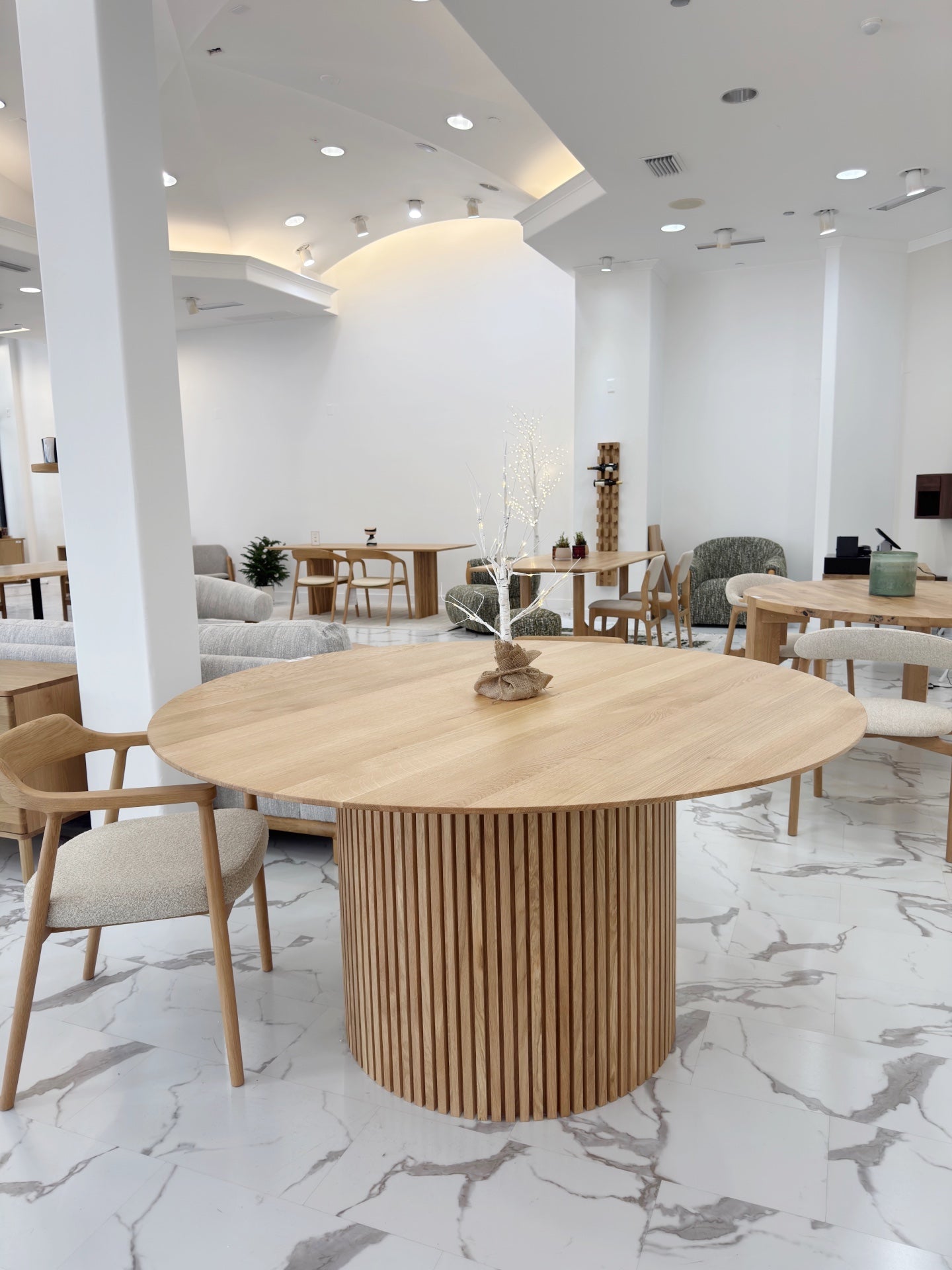 Handcrafted American oak round dining table with smooth surface and rustic warmth