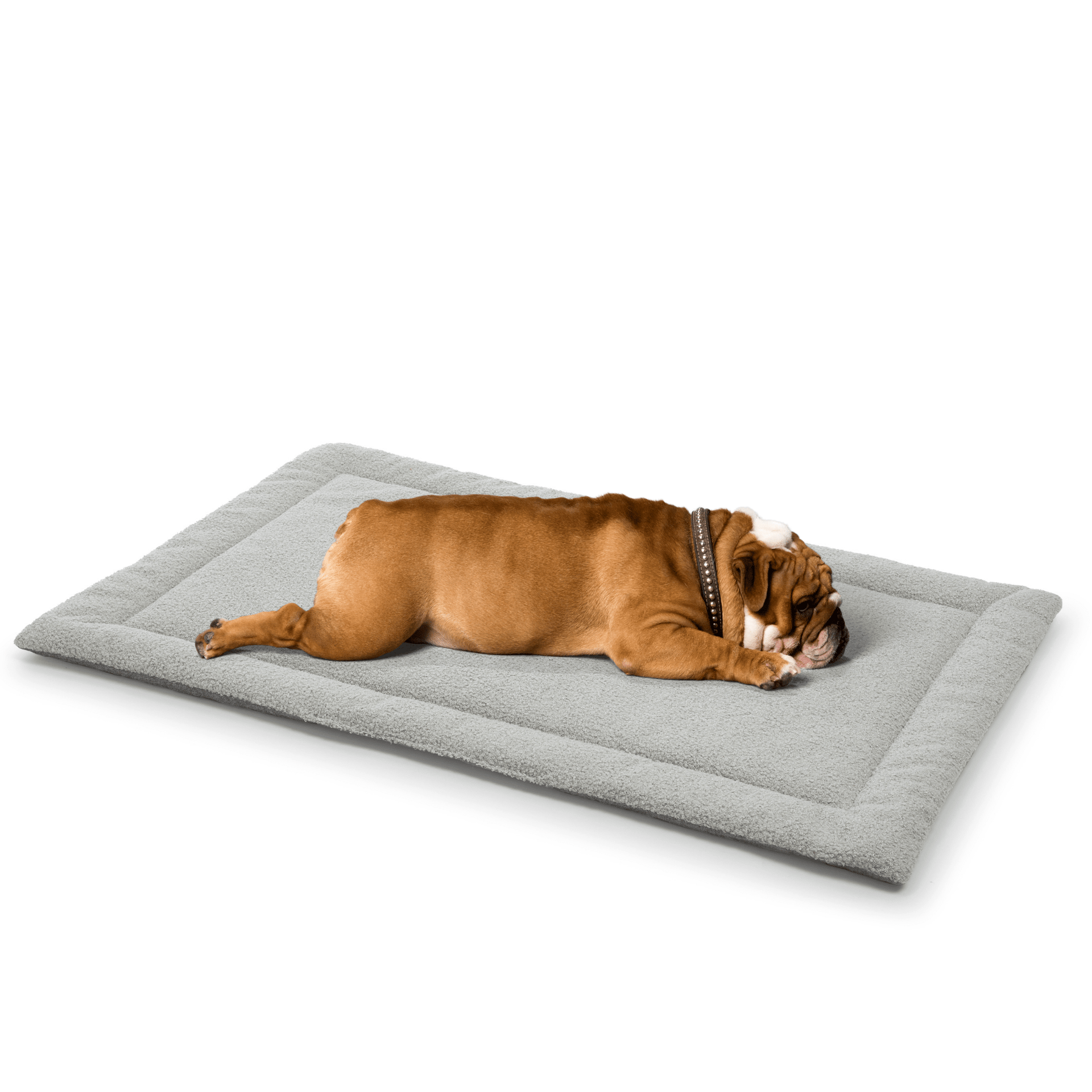 A relaxed bulldog lying comfortably on a soft gray dog mattress designed for ultimate pet relaxation.