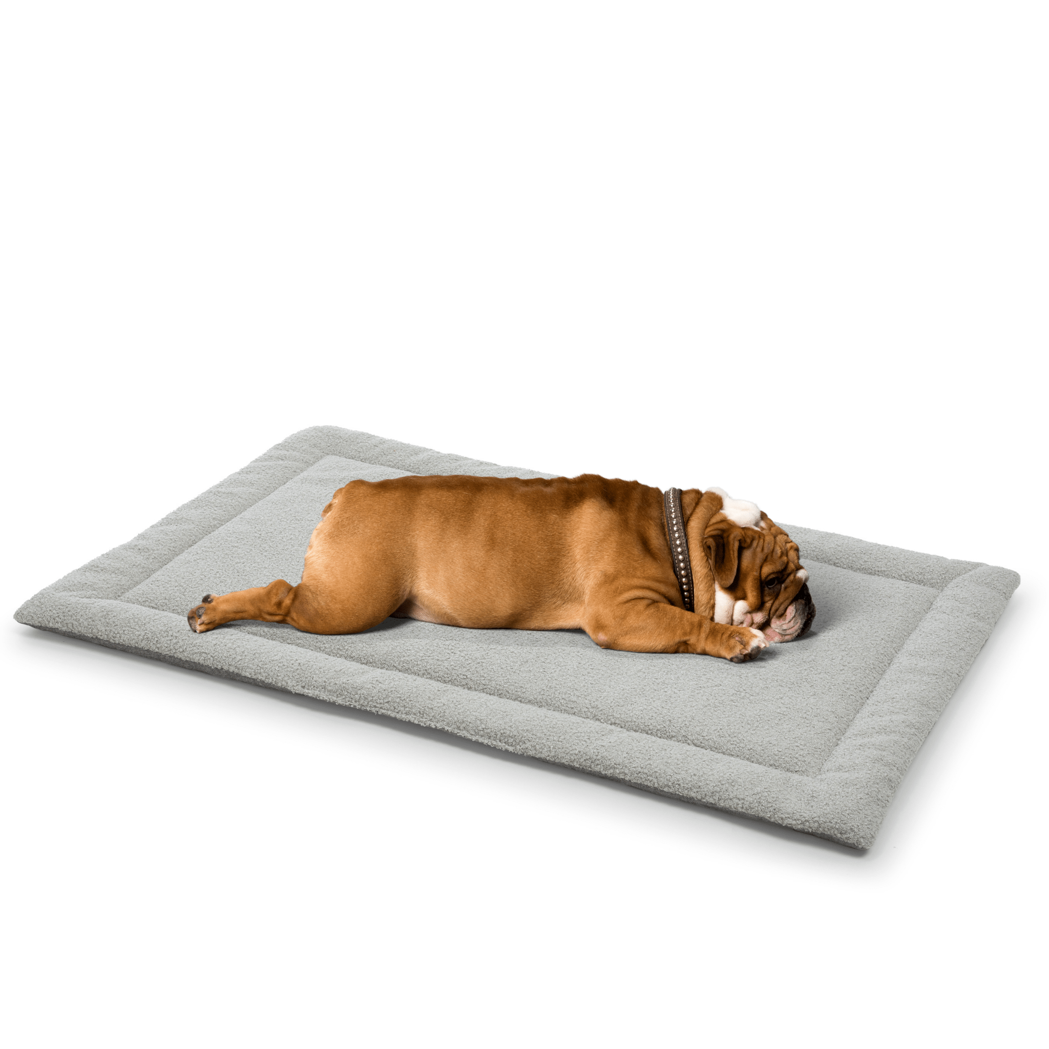 A relaxed bulldog lying comfortably on a soft gray dog mattress designed for ultimate pet relaxation.