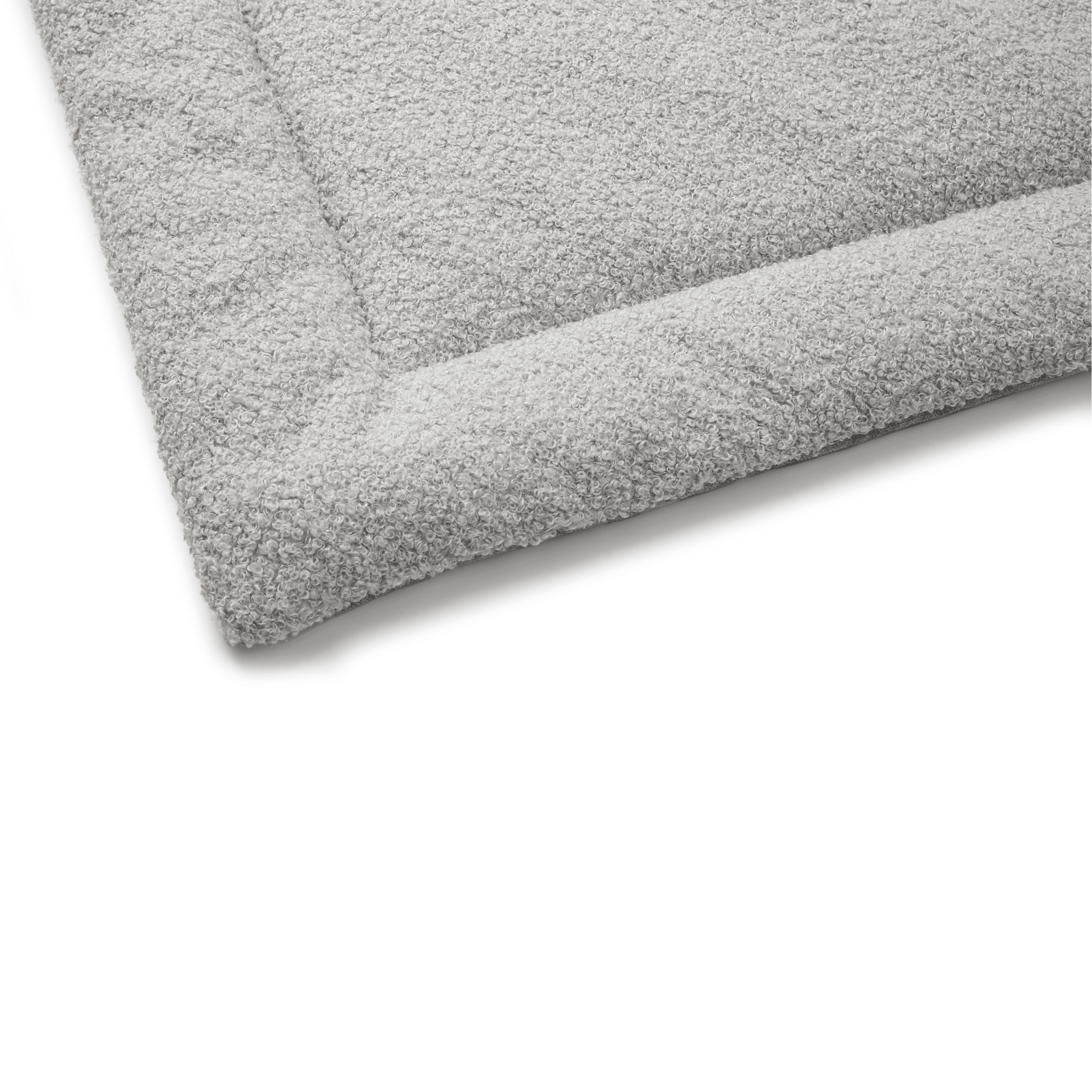 Close-up of a soft and durable gray bed with a textured surface for extra comfort.