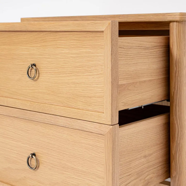 Wooden drawer with metal handles on a light background