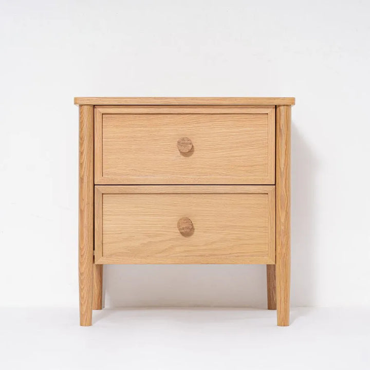 Wooden nightstand with two drawers on a white background