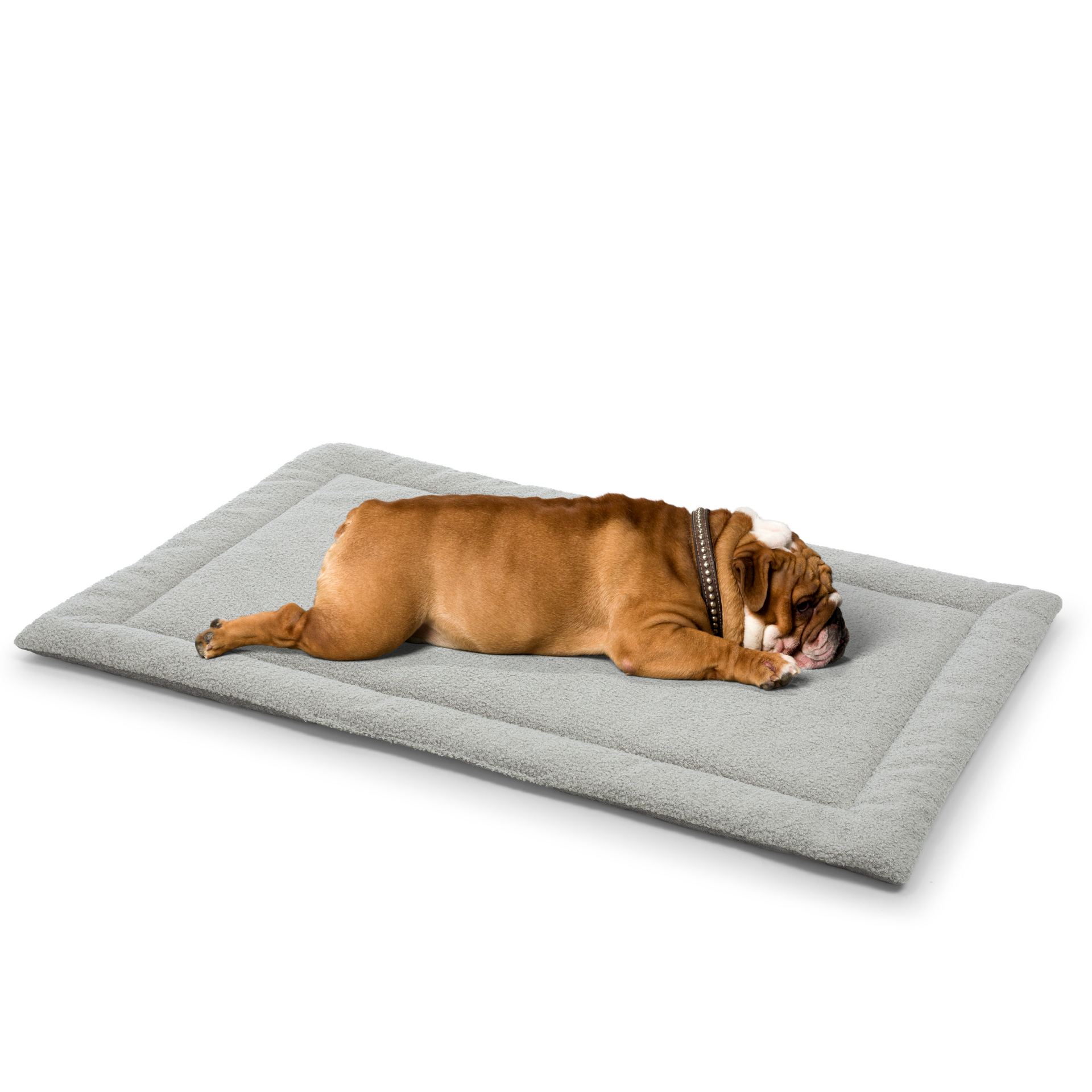 A relaxed bulldog lying comfortably on a soft gray dog mattress designed for ultimate pet relaxation.