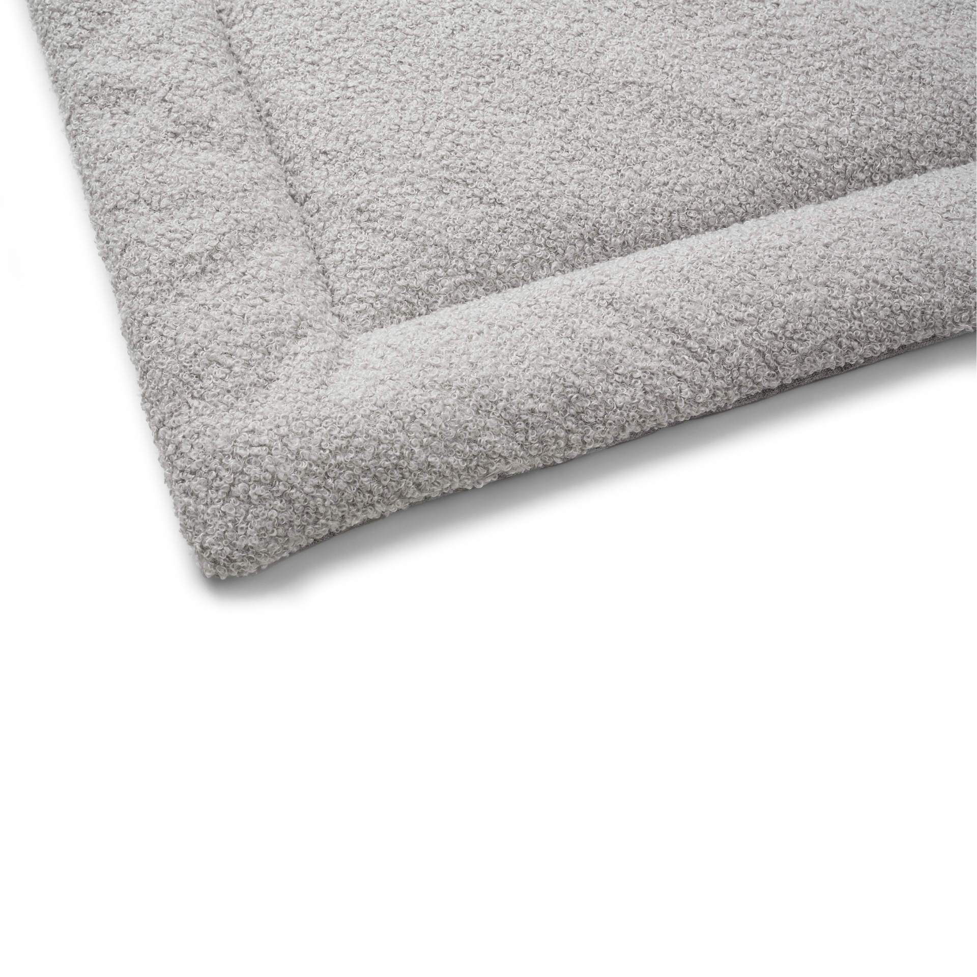 Close-up of a soft and durable gray bed with a textured surface for extra comfort.