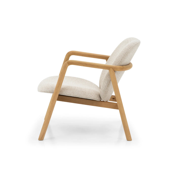 Theo Armchair – Cobble Fabric side profile highlighting flowing solid oak frame and soft textured cobble-colored upholstery, gallery position 1