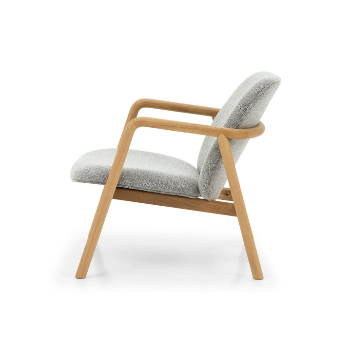 Theo Armchair – Noel Fabric side profile with smooth natural oak frame and softly curved armrest in light gray upholstery
