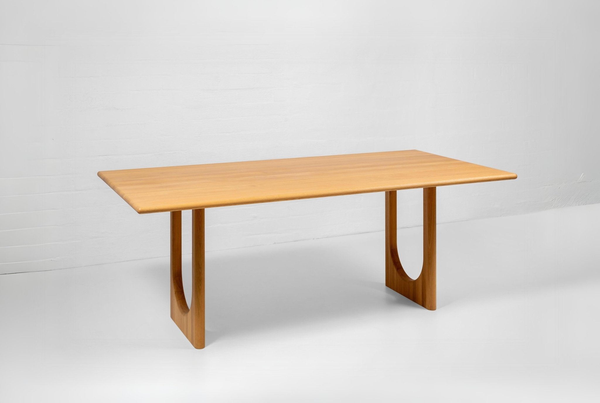Handmade extendable oak dining table with visible grain, knots, and warm natural tones
