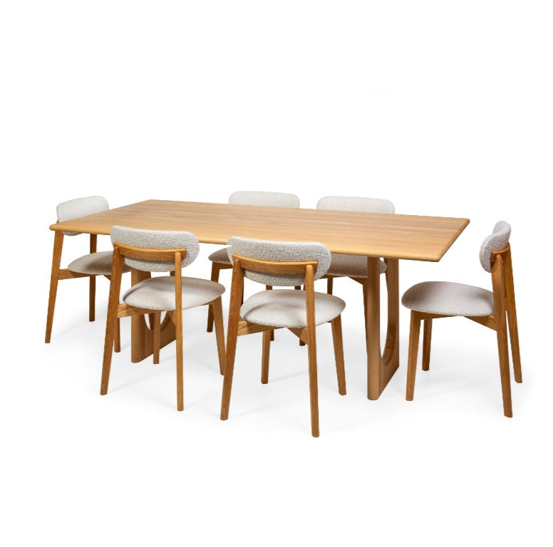 Natural Oak chair Theo with light fabric upholstery, seated around dining table Theo