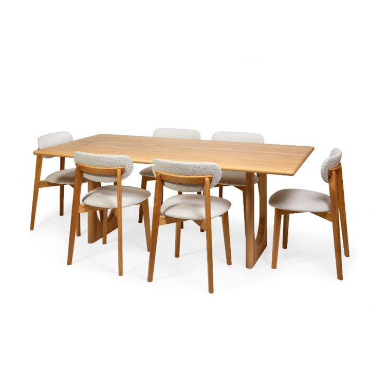 Natural Oak chair Theo with light fabric upholstery, seated around dining table Theo
