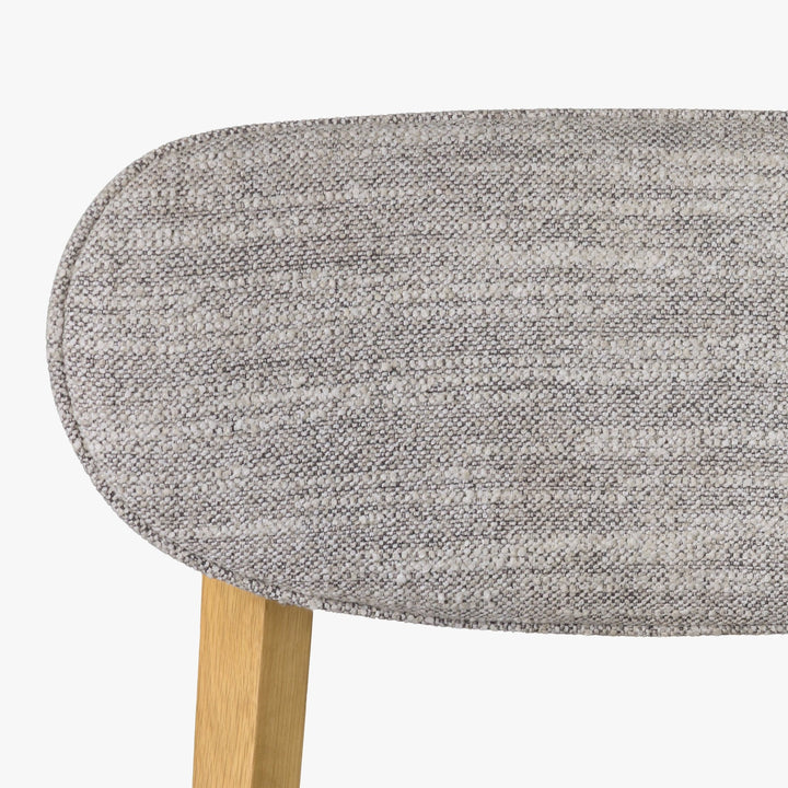 Theo American White Oak Dining Chair - close-up of textured light grey Leigh fabric backrest and matte lacquer oak frame