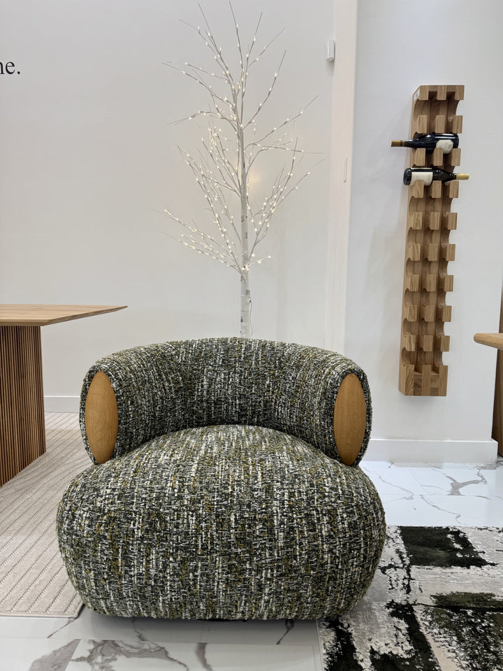 Theo – Swivel Armchair with Wooden Accents in textured green fabric with rounded shape and contrasting natural oak side details