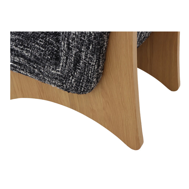 Tommy – Black Fabric Armchair with Oak Legs close-up on natural oak curved base and textured black-and-white fabric