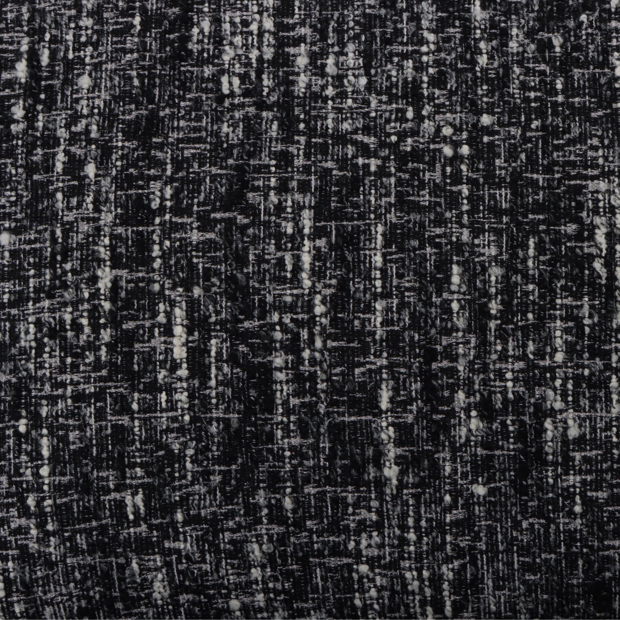 Tommy – Black Fabric Armchair with Oak Legs close-up on textured black-and-white fabric pattern, gallery position 1, Tugitool-Tommy-Must-kangas-9.webp