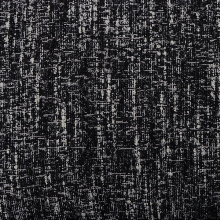 Tommy – Black Fabric Armchair with Oak Legs close-up on textured black-and-white fabric pattern