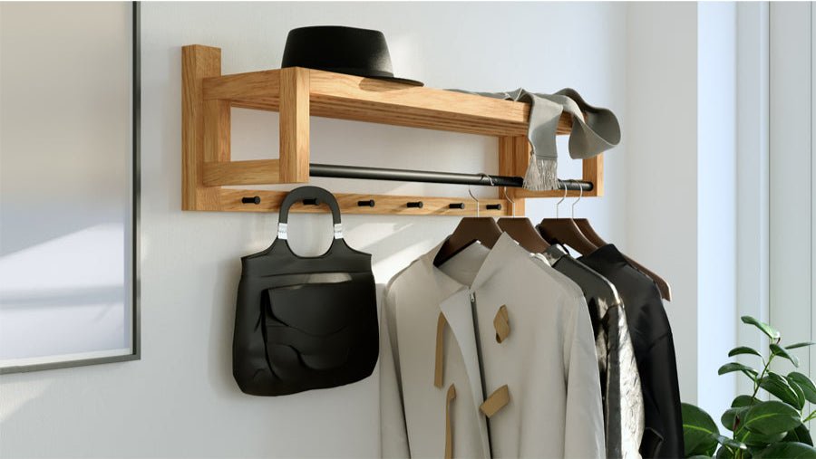 Stylish oak wall-mounted coat rack featuring a shelf and hooks, decorated with clothing and a black handbag