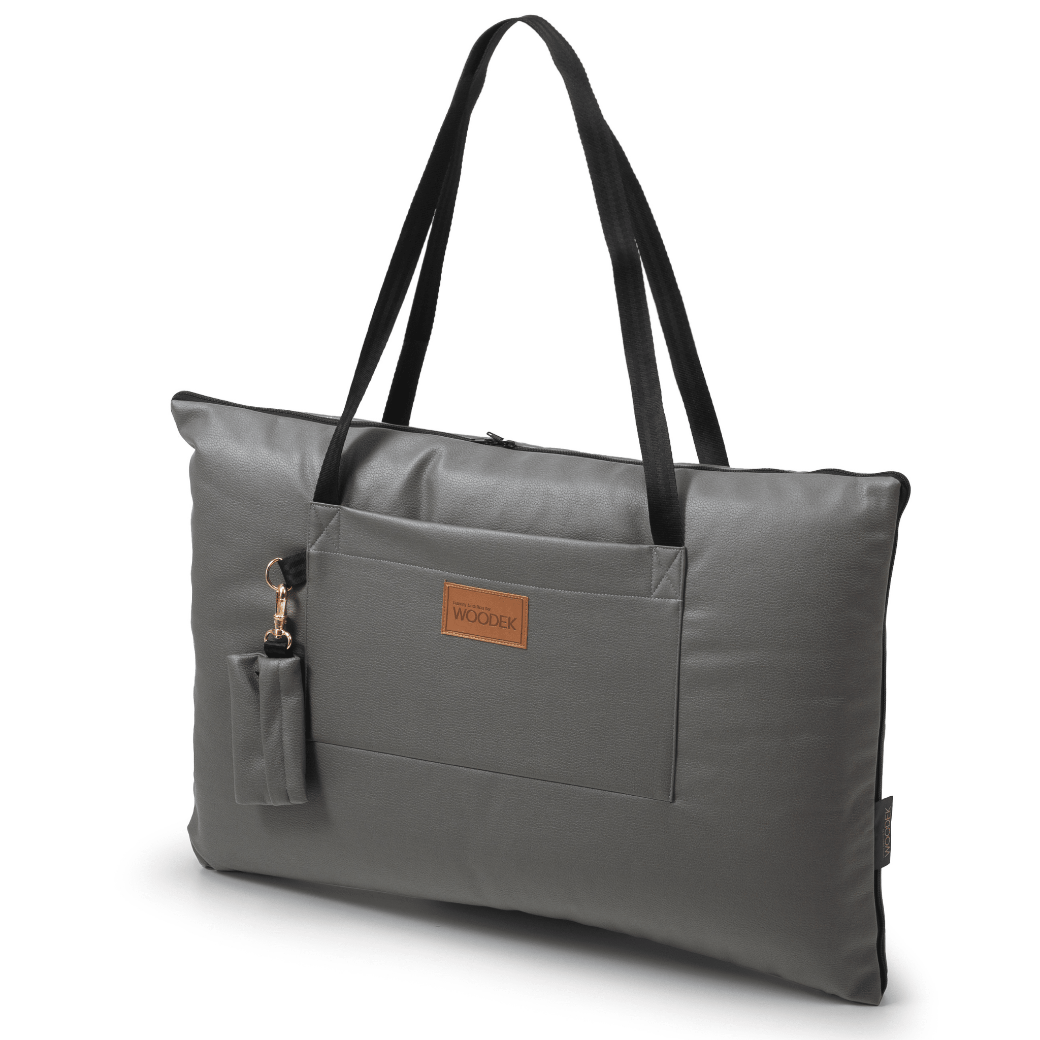 The Woodek 2-in-1 Dog Travel Bag & Mattress in grey is a rectangular tote with black straps, a front pocket, and an attached pouch. It features a brown “WOODEK” label, making it ideal for traveling with your dog.