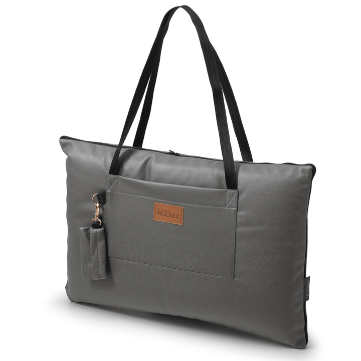 The Woodek 2-in-1 Dog Travel Bag & Mattress in grey is a rectangular tote with black straps, a front pocket, and an attached pouch. It features a brown “WOODEK” label, making it ideal for traveling with your dog.
